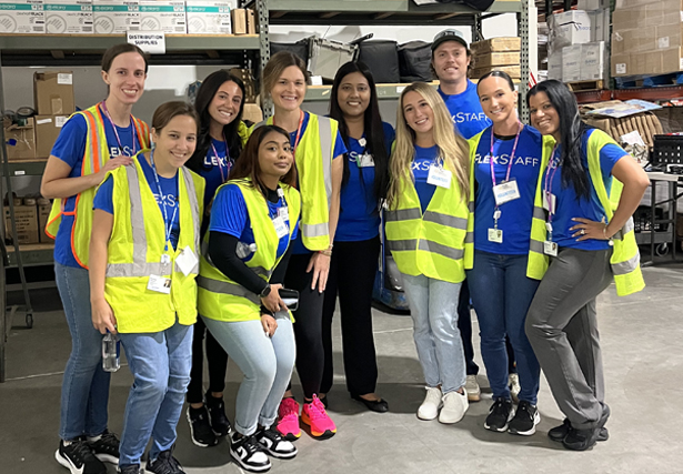 Image-2-v2 Two gentlemen in suits and ties with yellow boutonnieres stand together and smile.